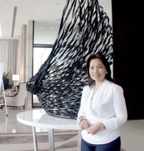 Artist Ann Pamintuan in front of her famous work displayed at the lobby of Seda Abreeza hotel in Davao City