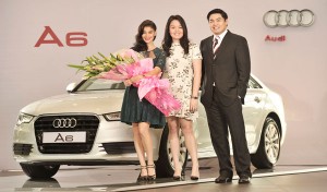 Audi brand ambassador Anne Curtis, with Audi Phils. head Benedicto Coyiuto (right) and Bea Coyiuto (center), poses beside the A6 high-performance luxury sedan.