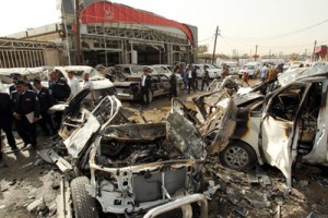 Policemen arrive to work on the site of a car bombing that targeted an area of car dealerships on Friday. AFP PHOTO 