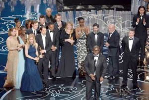 Director Steve McQueen (center) accepts the Best Picture award for 12 Years a Slave with (back row) actors Sarah Paulson, Benedict Cumberbatch, Lupita Nyong’o, screenwriter John Ridley, actor Chiwetel Ejiofor, producers Arnon Milchan, Dede Gardner, Jeremy Kleiner and Anthony Katagas, actress Adepero Oduye and producer Brad Pitt onstage during the Oscars at the Dolby Theatre on Sunday (Monday in Manila) in Hollywood, California. AFP PHOTO