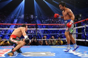 Manny Pacquiao (right) and Juan Manuel Marquez slug it out during their fourth encounter on December 8, 2012.  afp file photo