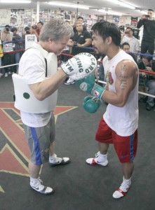 Manny Pacquiao (right) works the mitts with trainer Freddie Roach. AFP FILE PHOTO