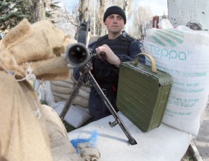 An Ukrainian soldier stands behind his machine gun machine on the territory of a military base in Donetsk on Sunday. Russia pledged it would not invade mainland Ukraine following its seizure of Crimea. AFP PHOTO