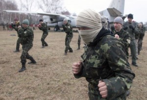 New recruits of the Ukrainian interim undergo training in unarmed combat not far from Kiev on Monday. Kiev had called last week for the initial mobilization of reservists, and approved the creation of a new National Guard of 60,000 volunteers, as Russian forces encircled Ukrainian military bases in Crimea. AFP PHOTO