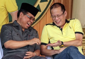 In this file photo taken on February 11, 2012, President Benigno Aquino (right) shares candies with Moro Islamic Liberation Front (MILF) chief Murad Ebrahim during a visit to the rebels’ stronghold in Sultan Kudarat, in Mindanao. The government and Muslim rebels will sign a pact on Thursday to end one of Asia’s longest and deadliest insurgencies. AFP PHOTO