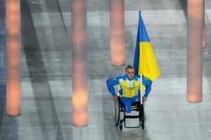 Sochi: Ukrainian paralympic cross-country skier and biathlete Mykhaylo Tkachenko enters the stadium the Fisht Olympic Stadium during the opening ceremony of the 2014 Winter Paralympic Games in the Black Sea resort of Sochi.  AFP PHOTO