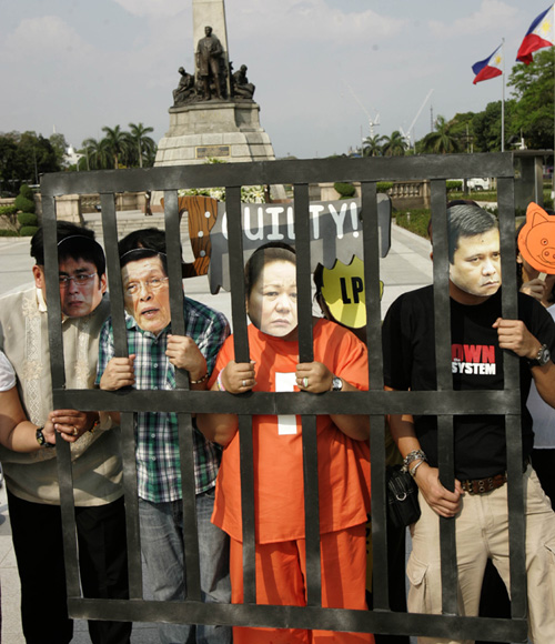 Actress and political activist Juana Change (center) wears a mask featuring the face of alleged pork scam mastermind Janet Napoles during an anti-pork barrel rally at Rizal Park on Wednesday. She is joined by protesters with masks representing Senators Juan Ponce Enrile, Ramon “Bong” Revilla and Jinggoy Estrada, all of whom face plunder charges with Napoles. Photo By Rene Dilan 