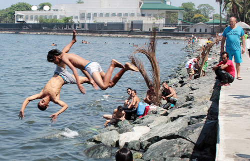 Swimming at Manila Bay may be dangerous because of the polluted water but these boys do not seem to mind as they enjoy their dip. Photo by Ruy L. Martinez 