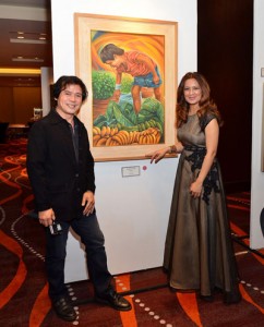 Carlos ‘Totong’ Francisco 3rd (left) and his painting ‘Tatlong Biyaya’ together with Yati Abdullah, DHL Express Philippines country manager