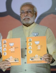 India’s Bharatiya Janata Party (BJP) Prime Ministerial candidate Narendra Modi poses with the party manifesto upon its release in New Delhi on Monday, on the opening day of voting in national elections. AFP PHOTO