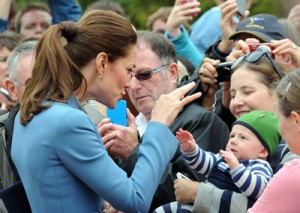 Catherine, the Duchess of Cambridge (left), plays with a child while on a walkabout in Seymour Square during a visit to the New Zealand city of Blenheim on Thursday. Britain’s Prince William, Kate and their son Prince George are on a three-week tour of New Zealand and Australia. AFP PHOTO