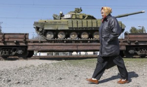 A woman walks past a trainload of Ukrainian tanks which are set to leave Crimean peninsular near the Crimean capital Simferopol on Monday. Russia’s President Vladimir Putin ordered last week all weapons and hardware left by the Ukrainian military after Crimea’s accession to Russia to be returned to Ukraine. AFP PHOTO