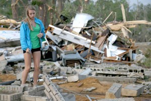 Chelsea Howard walks through what is left of her parent’s home after it was destroyed by a tornado that hit Tupelo, Mississippi. AFP PHOTO