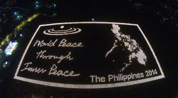 This photo released by Middle Way Meditation Institute shows an aerial shot of 56,680 candles in a bid to set a new world record for the largest flaming image in Iloilo City. Hundreds of people lined up in a dark, muddy field to form a giant map of the Philippines. The 56,000 candles appeared to have topped the old record of 35,478 candles forming a company logo in Pakistan in December 2009. AFP PHOTO