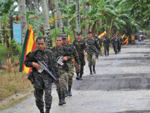 Moro Islamic Liberation Front (MILF) fighters patrol inside their base at Camp Darapanan in Maguindanao in this file photo. AFP PHOTO