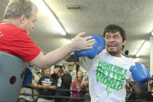 Boxer Manny Pacquiao (R) and trainer Freddie Roach (L) work the mitts during a media workout at the Wild Card Boxing Gym in Hollywood, California. AFP PHOTO