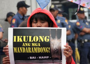 Human rights groups call for the jailing of plunderers in government during a rally in front of the Philippine National Police headquarters in Camp Crame on Wednesday. The rallyists also called for the release of all political prisoners and the resumption of peace talks with the communist National Democratic Front. PHOTO BY MIKE DE JUAN
