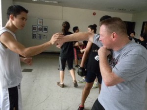 Rodney Hitchcock (left) teaches a student punching techniques. CONTRIBUTED PHOTO