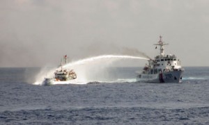 This photograph taken on May 2, 2014 and released on May 7, 2014 by the Vietnamese Foreign Ministry shows a China Coast Guard ship (right) using a water cannon on a Vietnamese ship in the disputed waters in the South China Sea, also known as the West Philippine Sea. AFP PHOTO