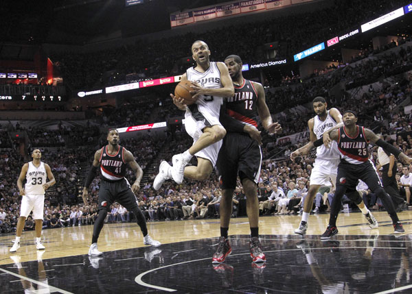 San Antonio, Texas: Tony Parker No.9 of the San Antonio Spurs leaps past LaMarcus Aldridge No.12 of the Portland Trail Blazers in Game One of the Western Conference semifinals during the 2014 NBA Playoffs at the AT&T Center in San Antonio, Texas. AFP PHOTO