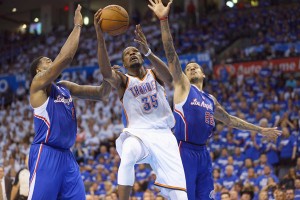 Kevin Durant No.35 of the Oklahoma City Thunder takes a shot against DeAndre Jordan No.6 and Matt Barnes No.22 of the Los Angeles Clippers in Game 2 of the Western Conference semifinals during the 2014 NBA playoffs at Chesapeake Energy Arena in Oklahoma City, Oklahoma. AFP PHOTO