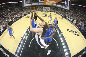 Tiago Splitter No.22 of the San Antonio Spurs takes a shot against Kendrick Perkins No.5 of the Oklahoma City Thunder in Game Two of the Western Conference Finals during the 2014 NBA Playoffs at AT&T Center in San Antonio, Texas. AFP PHOTO