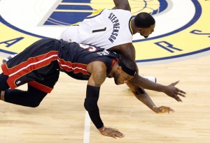 Lance Stephenson No.1 of the Indiana Pacers and LeBron James No.6 of the Miami Heat dive for a loose ball during Game Five of the Eastern Conference Finals of the 2014 NBA Playoffs at Bankers Life Fieldhouse in Indianapolis, Indiana. AFP PHOTO