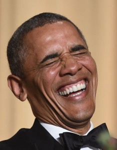 US President Barack Obama laughs as he listens performer Joel McHale telling jokes during the White House Correspondents’ Association Dinner. AFP PHOTO