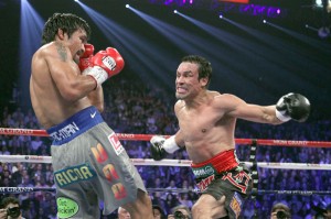 Manny Pacquiao (left) and Juan Manuel Marquez exchange blows during their fourth match in 2012. AFP FILE PHOTO