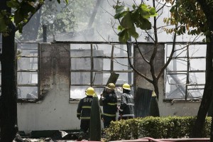 Firefighters cautiously approach the gutted Explosives and Ordnance Division office at Fort Bonifacio, which was struck by a fire and a series of explosions on Wednesday. PHOTO BY RENE DILAN