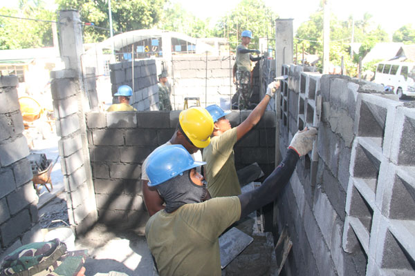 American and Filipino soldiers join in building comfort rooms and schools in Legazpi City as part of the socio-civil component of Balikatan, the joint exercises between the US and Philippine military. PHOTO BY RHAYDZ BARCIA