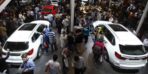 Beijing Auto Show visitors and journalists gather around the newly launched BMW X3 and X5, which are forecast to sell well given China market’s preference for SUVs. AFP PHOTO
