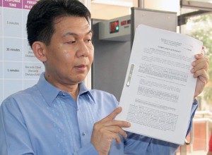 Lawyer Oliver San Antonio holds a copy of the complaint against Transportation Secretary Emilio Abaya. PHOTO BY MIKE DE JUAN