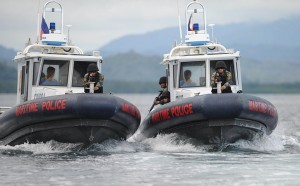 In this photo taken on June 6, members of Philippine Maritime police special boat unit, riding on US-made gun boats, maneuver as they simulate an apprehension of poachers during a training exercise off Honda Bay in Puerto Princesa, Palawan island. With a top speed of more than 83 kilometers an hour and equipped with a radar, a mounted machine gun and capability to operate at night, the gunboats, are more than a match for most fishing boats. AFP PHOTO