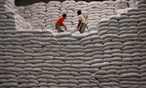 Workers stack sacks of rice inside the National Food Authority warehouse in Quezon City Wednesday. Rice prices rose by P2 per kilo in Metro Manila markets.  Photo By Miguel De Guzman 