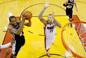 Kawhi Leonard No.2 of the San Antonio Spurs goes to the basket against Chris Andersen No.11 of the Miami Heat during Game Four of the 2014 NBA Finals at American Airlines Arena on June 12, 2014 in Miami, Florida. AFP PHOTO