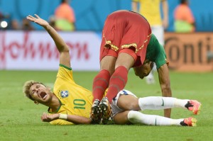 Brasília, Distrito Federal, Brazil: Brazil’s forward Neymar reacts in pain following a tackle by Cameroon’s midfielder Joel Matip during the Group A football match between Cameroon and Brazil at the Mane Garrincha National Stadium in Brasilia during the 2014 FIFA World Cup. AFP PHOTO