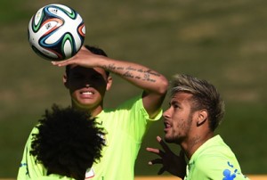 Brazil 's defender and captain Thiago Silva(back)watches his teammate forward Neymar head the ball during a training session at  the squad's Granja Comary Training complex in Teresopolis during the 2014 FIFA football world cup