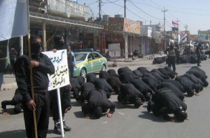 Members of the Shiite Muslim Mehdi Army militia pray as they show their willingness to join the fight against militants led by the jihadist Islamic State of Iraq and the Levant (ISIL) on Saturday, in the Iraqi city of Kirkuk. Iraqi security forces on announced they were holding their own in several areas north of Baghdad, but officials said insurgents led by ISIL seized one of three official border crossings with Syria. AFP PHOTO