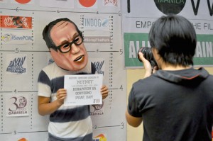 An activist posing as President Benigno Aquino 3rd gets his mug shot taken during the launching of the “Hatol ng Bayan” at the Polytechnic University of the Philippines on Sunday. Militant groups started a protest countdown campaign leading to Aquino’s fifth State of the Nation Address in July. PHOTO BY EDWIN MULI