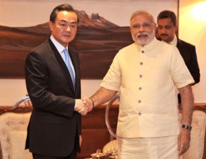 In this handout photograph released by the Press Information Bureau (PIB) on Monday, Chinese Foreign Minister Wang Yi (left) and Indian Prime Minister Narendra Modi (right) shake hands during a meeting in New Delhi. AFP PHOTO