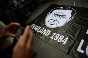 A banner carrying a drawing depicting Thai army chief General Prayut Chan-O-Cha and a reference to George Orwell’s famous dystopian novel “1984” is displayed during a gathering at a shopping mall which was broken up by security forces in downtown Bangkok on Sunday. AFP PHOTO