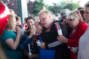 The family of Emilio Hoffman, one of the two victims of a shooting at the Reynolds High School on Wednesday, weeps at a candle-light vigil held for the fatalities the same day. AFP PHOTO