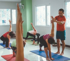 Yoga instructor Jasper Colina and his students