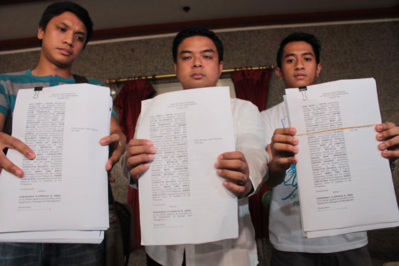 Kabataan party-list Rep. Terry Ridon (center) and members of Youth Act Now! hold copies of the plunder complaint they filed against Budget Secretary Florencio Abad at the Office of the Ombudsman.   Photo By Ruy Martinez 