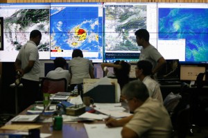 Weather forecasters monitor the path of Storm Glenda at the Philippine Atmospheric Geophysical and Astronomical Services Administration (Pagasa) office in Quezon City on Monday. Photo By Miguel De Guzman