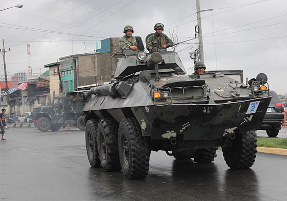 Amid rumors of a destabilization plot, an Army convoy consisting of an armored personnel carrier and several military trucks is spotted in Parola, Tondo, Manila, on Thursday.Photo by RUY MARTINEZ