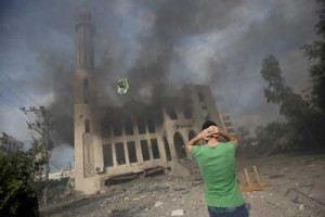 A Palestinian man reacts in front of a destroyed mosque after it was hit by an Israeli air strike on Tuesday in Gaza City. AFP PHOTO