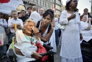 Relatives of victims of the downed Malaysia Airlines flight MH17 react as people wearing white clothes gather in memory of the victims Thursday in Amsterdam. AFP PHOTO