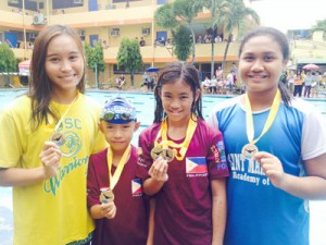 (From left) Gold medalists Loren Dale Echavez, Michael Gabriel Lozada, Kyla Soguilon and Celine Delotavo on the first day of the Philippine Swimming League (PSL) 61st Leg Series at the John B. Lacson Foundation Maritime University swimming pool in Iloilo. CONTRIBUTED PHOTO